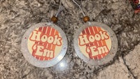 two hook em ornaments on a marble counter