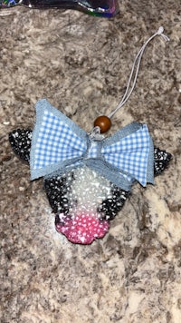 a cow ornament with a bow on it