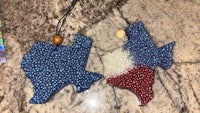 two texas ornaments on a marble counter