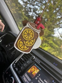 a car with a jar of lemons on the dashboard